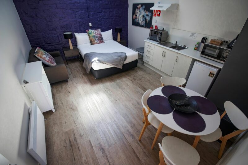 picture showing the interior of the self contained rooms with bed , kitchenette and dining table