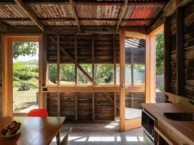 dining kitchen area with horizontal window and open glazed door looking towards garden