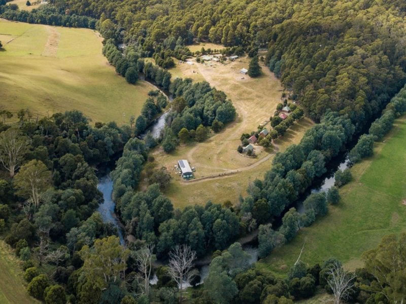 Five cottages are sitting on a ridge above the river