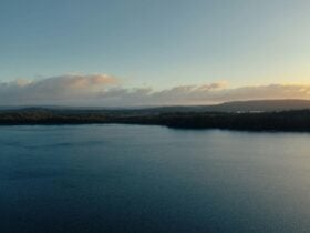 Sunset over the still waters of Lake Binney