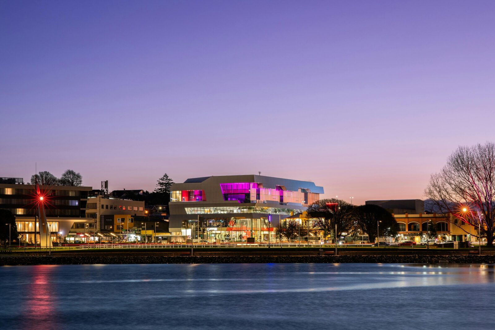 paranaple convention centre accross the river lit up at dusk