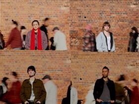 portraits of four people on a busy street in front of a brick wall