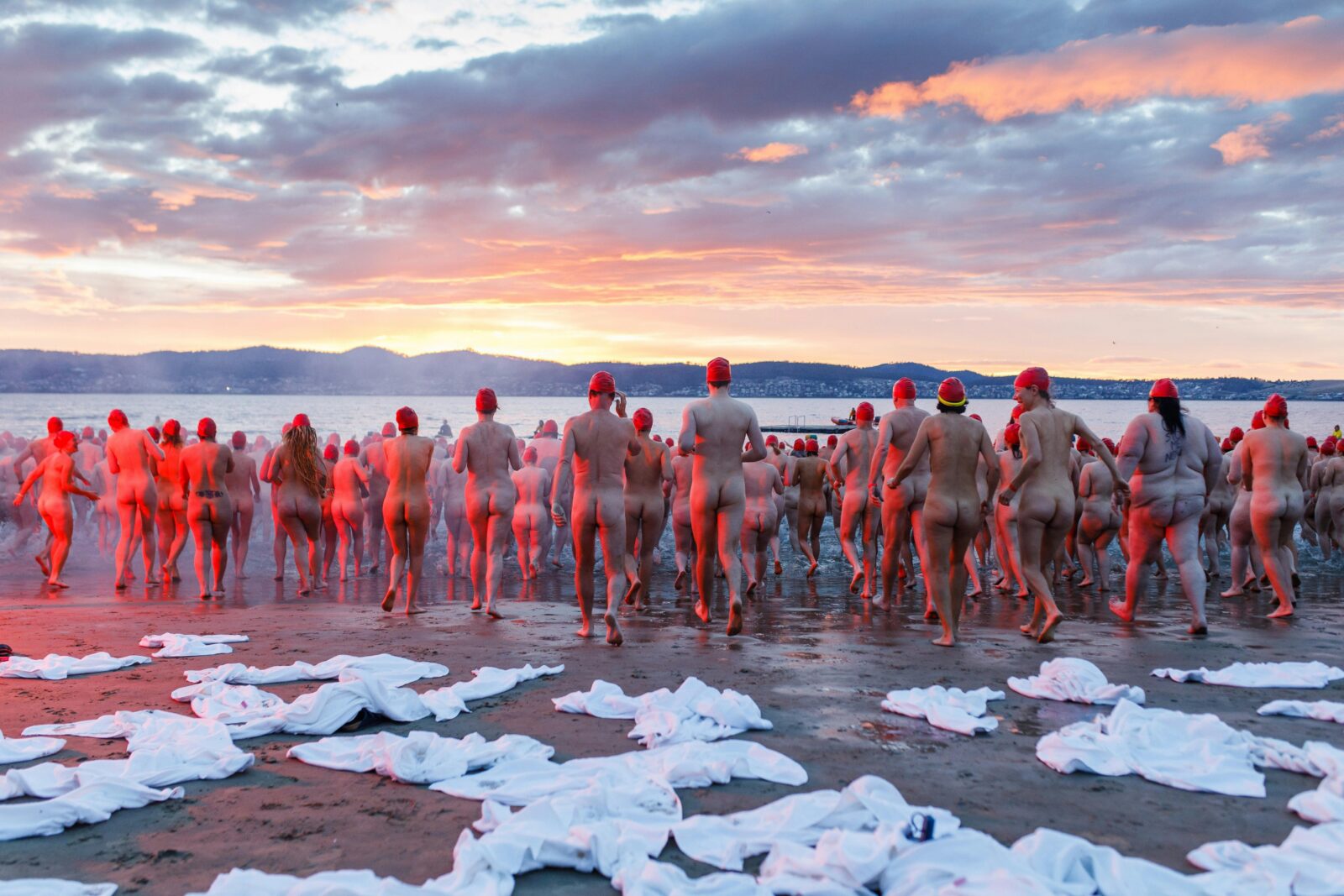 Thousands of people run into the River Derwent at sunrise for Dark Mofo