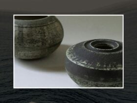 Two rustic ceramic vessels on table.