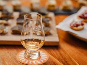 a dram of Hellyers Road Whisky on table in front of canapes