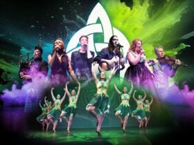 dancers and musicians in front of a celtic knot