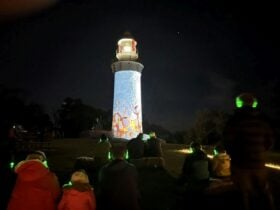 Looking up at projections on a lighthouse
