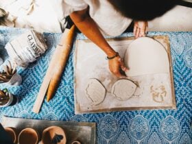 A variety of tools and clay for making ceramics are shown on the table,