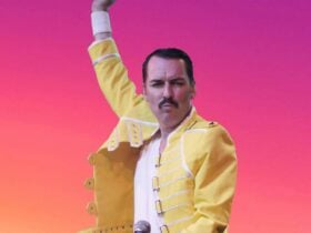 freddie mercury look a like on a pink background