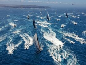 Ocean racing yachts cross the starting line in Sydney Harbour on their way to Tasmania