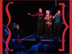 Three performers on stage