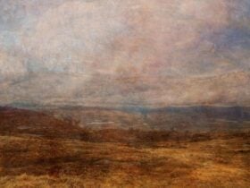 landscape image of dry brown land and blue cloudy sky