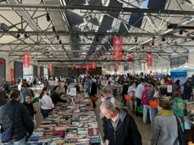 Variety Monster Bookfair tables of books with people looking through them