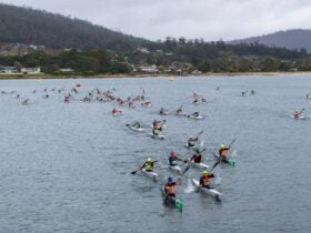75 kayakers paddling off the event startline