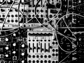 A series of knobs, dials and cords plugged into electric music equiment