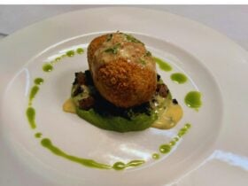 crispt ham hock croquettes served on a peas puree and leekl oil