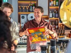 Dill Pickle Club bartender holding a record
