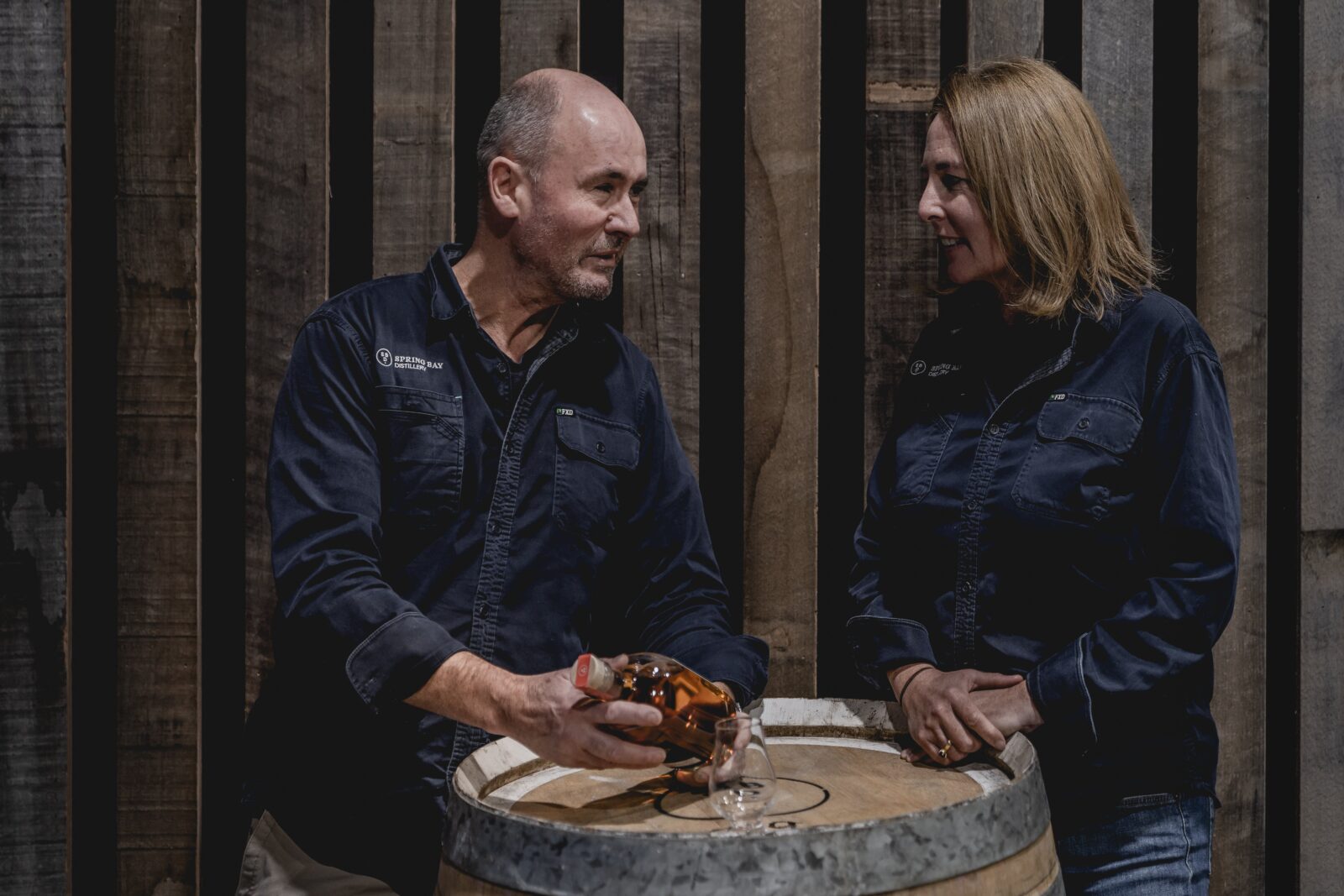Cam and Suzy Brett with a barrel and whisky