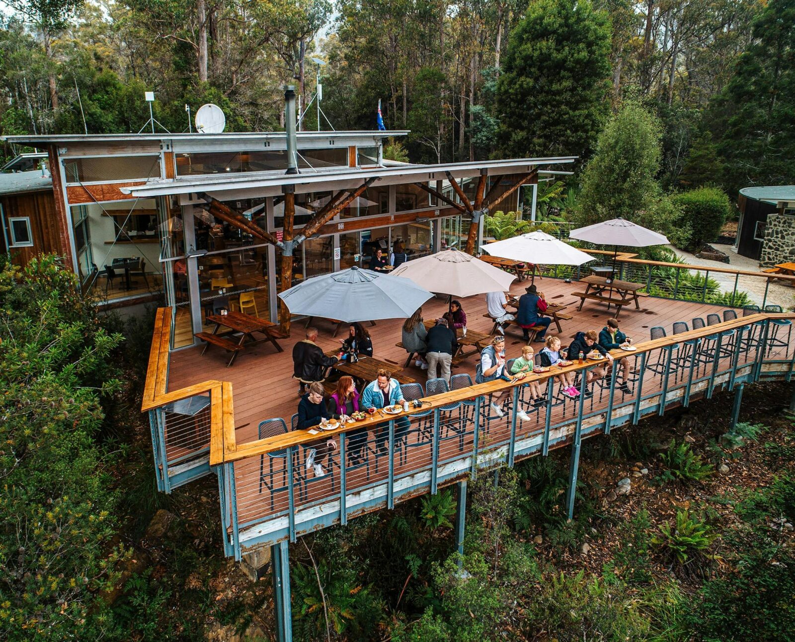 a wide shot of the Tahune Adventures cafe deck, people sitting outside and enjoying food