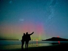 Ali and Rian standing at 7 mile beach watching Aurora