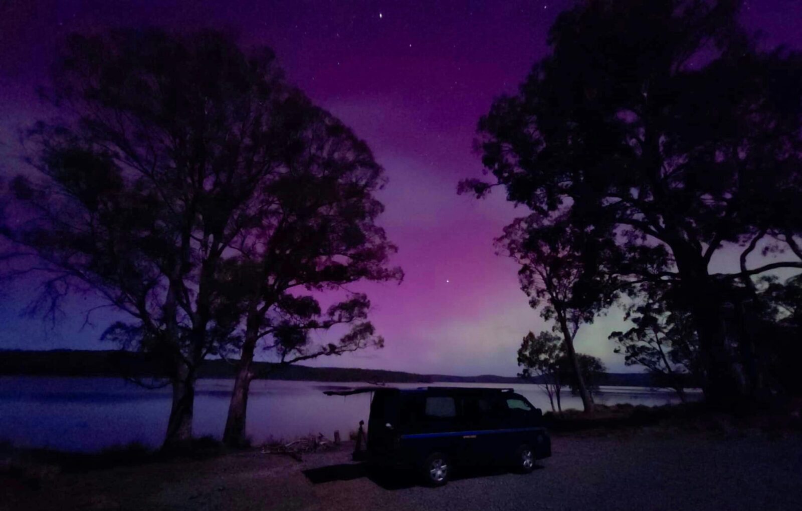 Sapphire chaser HiAce camper van parked near lake watching Aurora