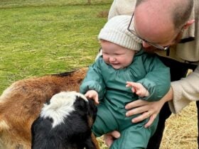 Man and baby meet goat