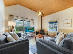 Lounge area with a small fireplace, television, couches and tea table