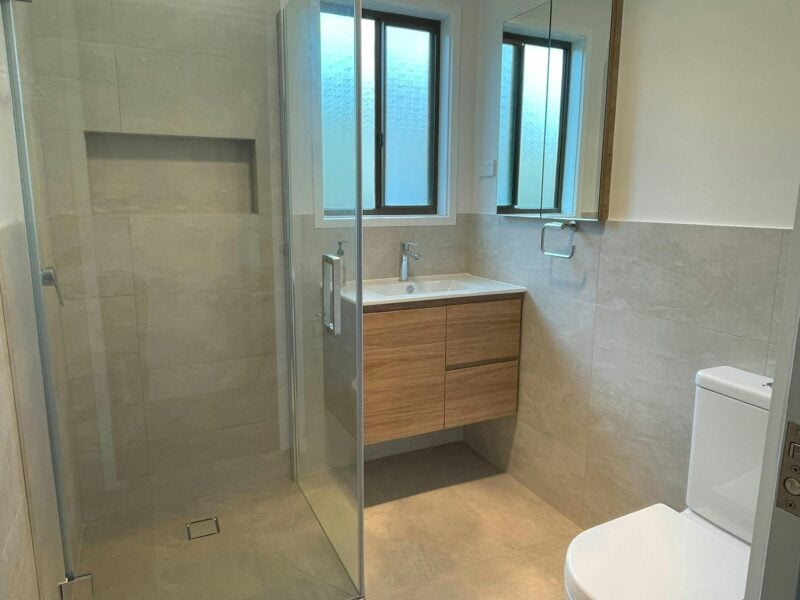 Image of newly renovated bathroom showing shower, vanity and toilet