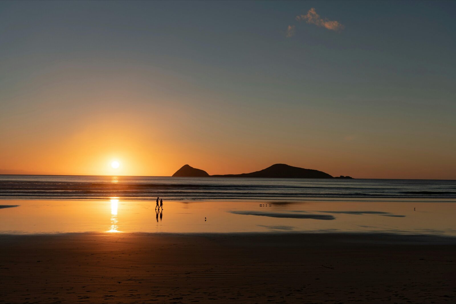 Couple walking along beach Wilsons Prom