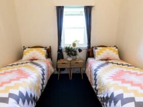 Photo of two beds with a table between them