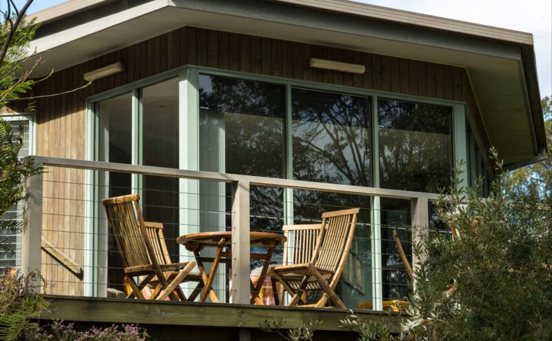Outdoor dining area on front balcony of Lodge