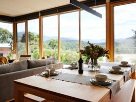 Interior designed spacious dining with spectacular mountain views in luxury Yarra Valley villa.
