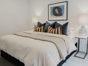 Hester arthouse townhouse bedroom with bed, table side lamp and painting hanging on the wall