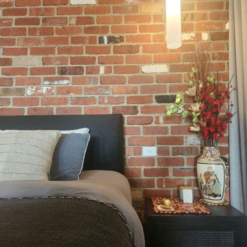 Bed in front of recycled Brick wall