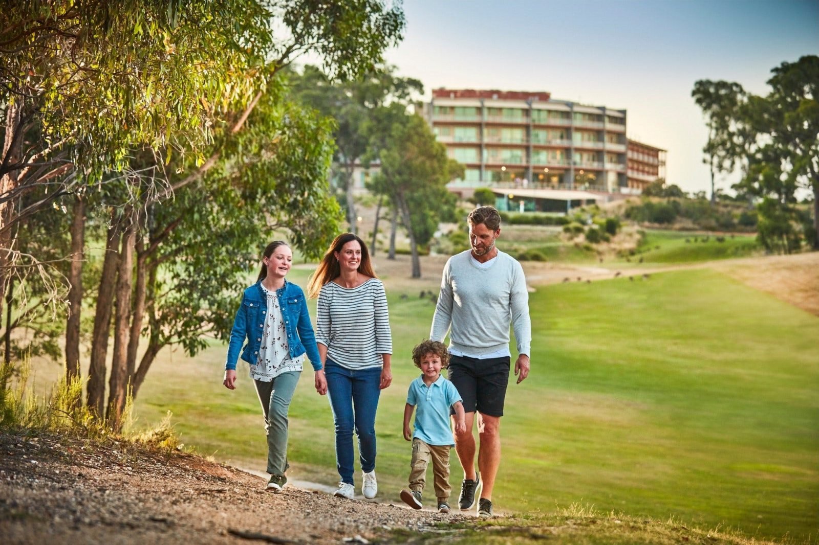 Happy family walking along track