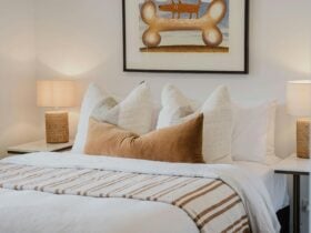 Reed arthouse townhouse bedroom with bed, table side lamps and painting on the wall