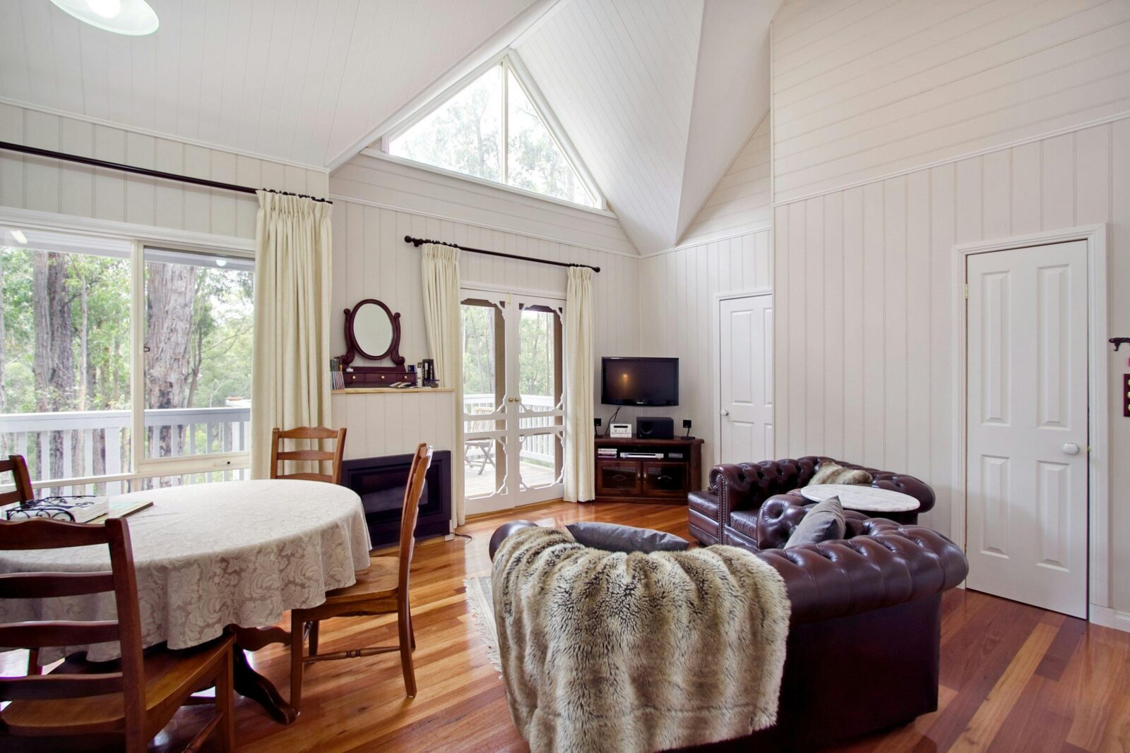 One Bedroom Cottage lounge opening onto spacious balcony