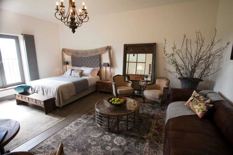 Tuscan Suite including a queen sized bed and a lounge suite.