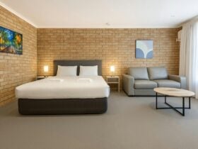 Bedroom with bed and small couch