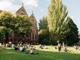 Abbotsford Convent Building and Heritage Gardens with visitors relaxing on the lawn in the sun