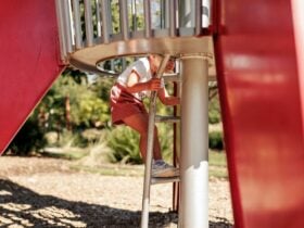 Child starting to climb up the ladder of the rocket.