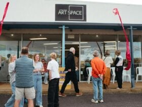 People gathered outside Anglesea Art Space, chatting and entering during an exhibition opening.
