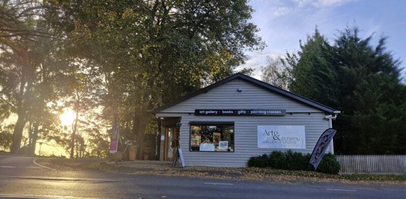 The building of Art & Alchemy Gallery & Studio from across the road with sun to the left