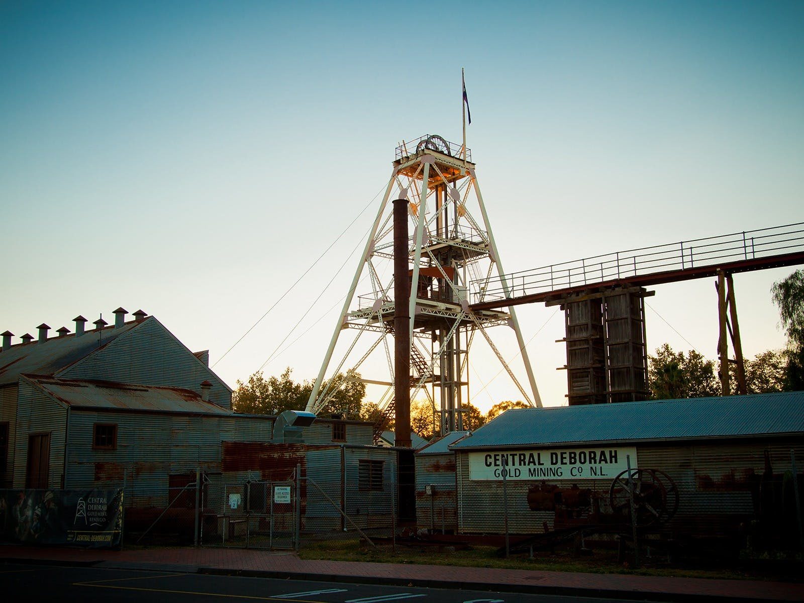 Poppet Head and heritage mining buildings with sunset in background