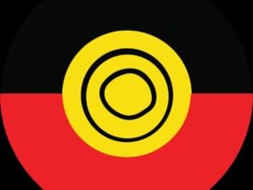 A circle logo with the top half in black, the bottom half in red and a yellow circle in the centre