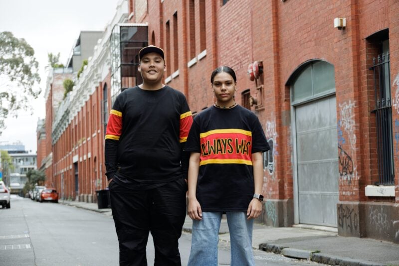 two people standing in a laneway wearing clothing the gaps