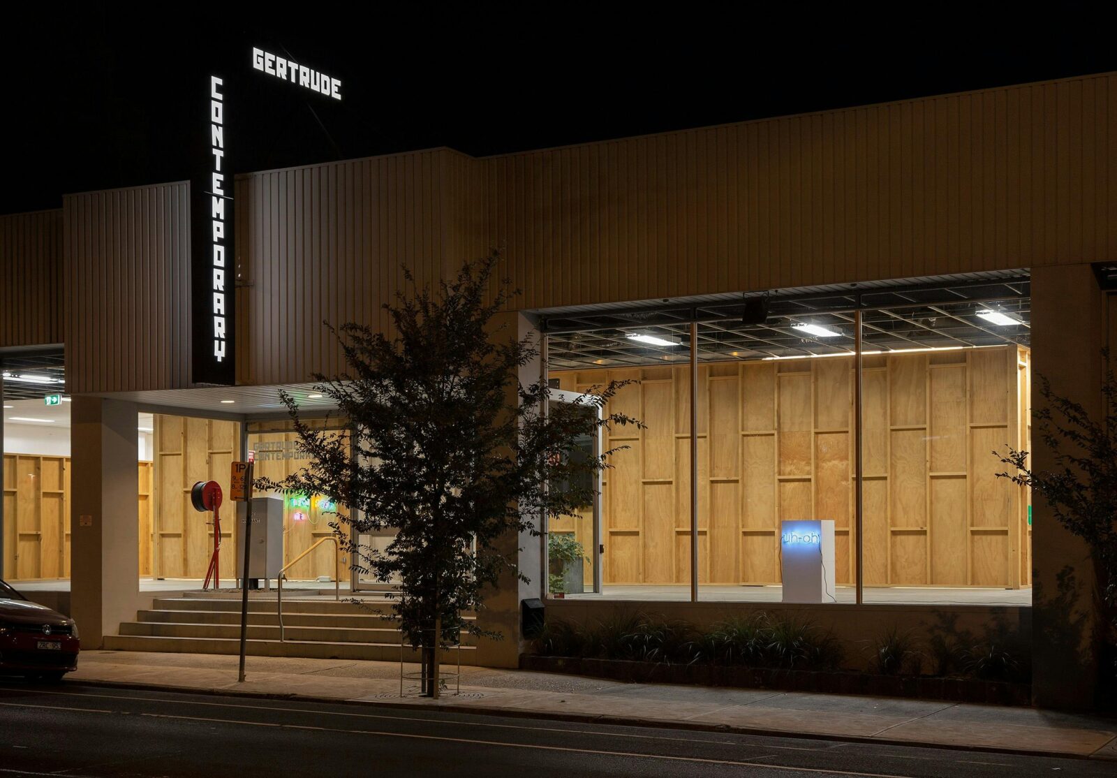 Facade of contemporary art gallery at night time.
