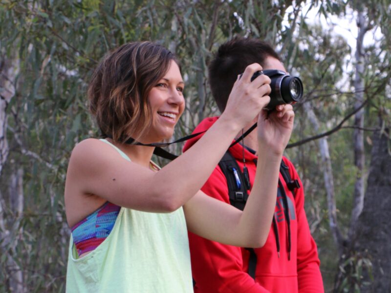 A couple taking photos of the magnificent forest