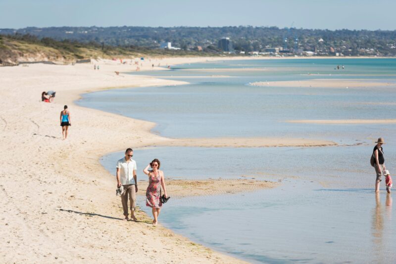 Couple walking on Seaford Beach