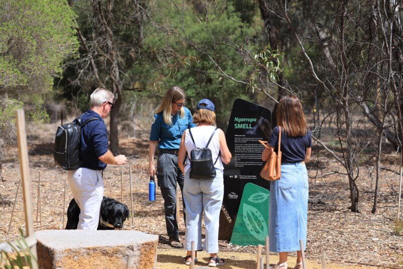 Visitors enjoying the garden with a park ranger